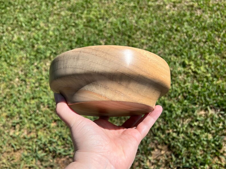 Camphor bowl with wide opening and narrower base - another side view of wooden bowl in natural light