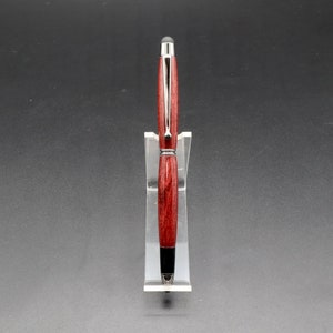 Front view of Purpleheart stylus pen with gun metal hard in clear pen stand over black background