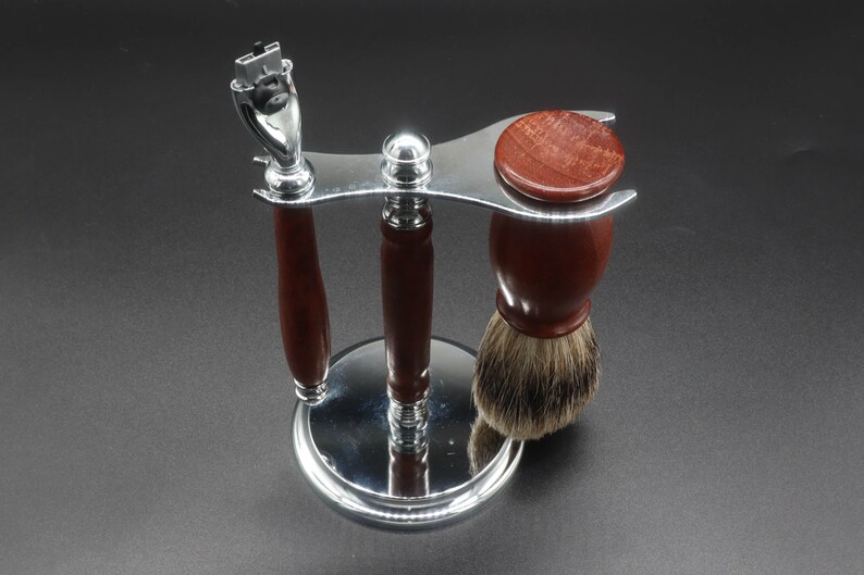 Eucalyptus shaving set with brush, stand, and razor handle over a dark background