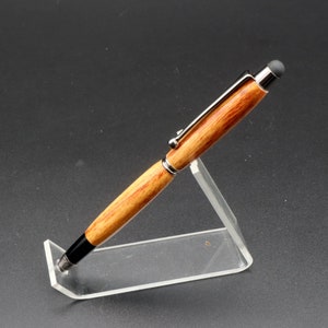 Side view of Canarywood stylus pen with gun metal hardware in pen stand over black background