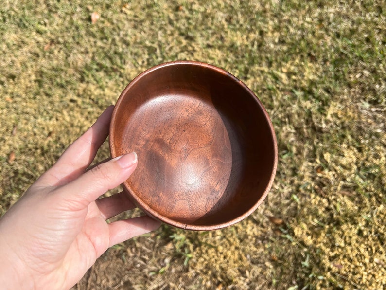 Indian Rosewood wooden bowl outside in natural light - showing inside of the bowl