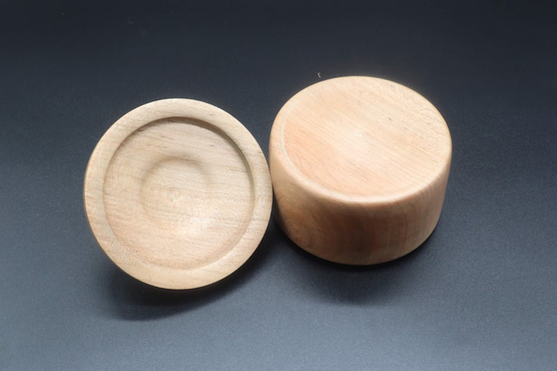 Wooden bowl made of maple and tulipwood with lid -- showing the bottom side of the bowl and the lid.