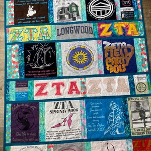 May include: A quilt made of various t-shirts with the letters ZTA, the words "Go Greek", "Zeta, Zeta!" and "Bid Day Spring 2011", and other text and images.