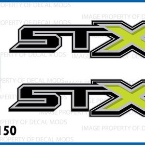 May include: Two black and silver decals with a yellow X and the word "STX" in black. The decals are for a Ford F150.