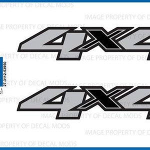 May include: Two black and silver 4x4 decals with a black and white "X" in the middle. The decals are on a white background. The text "OFFICIAL LICENSED PRODUCT" is also visible.