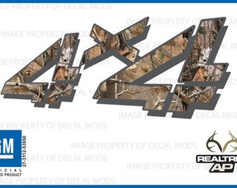 May include: A 4x4 decal with a camouflage pattern in brown, tan, and grey. The decal features the text "REALTREE AP" and the GM logo.