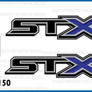 May include: Two black and silver Ford F150 STX decals with a blue X. The decals are officially licensed Ford products.