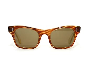 May include: Brown and tan tortoise shell sunglasses with brown lenses.