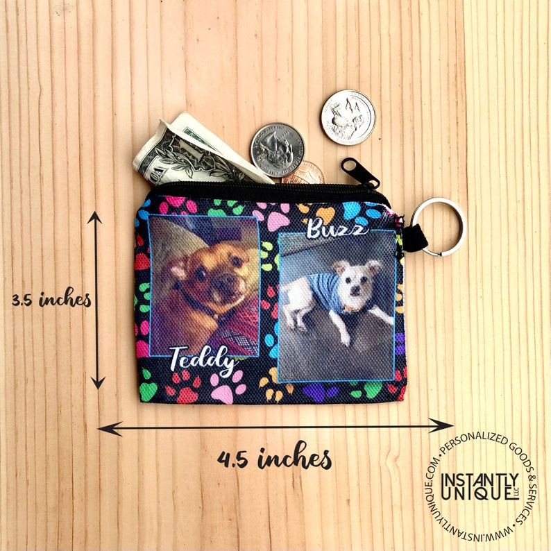 May include: A black zippered pouch with a paw print design. The pouch has two photos of dogs, one named "Teddy" and the other named "Buzz". The pouch measures 4.5 inches wide and 3.5 inches tall.