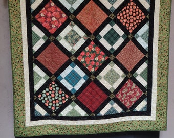 65"x 65" Christmas Holly Quilt, Wall, Table Topper. Premium Cotton fabric in multiple shades of Greens, reds, black and white as neutral.