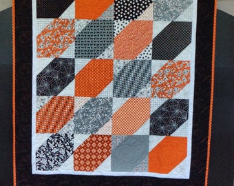 48 x 58 Halloween, Fall Quilt-Wall, Table Topper. Premium Cotton fabric in multiple shades of Black, gray, orange and white as neutral.