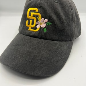 SD with hibiscus flower on Adams dad hat