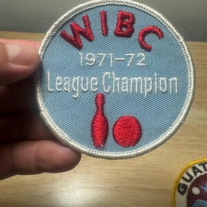 May include: A blue and white embroidered patch with the text "WIBC 1971-72 League Champion" and a red bowling pin and ball.