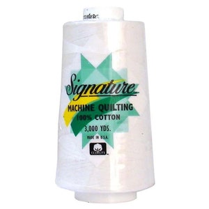 May include: A white spool of Signature Machine Quilting thread, made of 100% cotton. The spool is labeled with the brand name, thread type, and yardage: 3,000 yards. It is made in the USA.