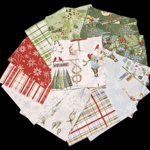 May include: A collection of Christmas-themed fabric squares in various patterns and colors. Designs include snowflakes, plaid, and winter scenes with trees, birds, and a welcoming sign. The fabrics are arranged in a circular pattern against a black background.