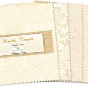 May include: A pack of five 5-inch fabric squares in various cream and beige shades with different patterns. The pack is labeled "Vanilla Cream 5 Karat Gems".