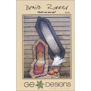 May include: A sewing pattern for a table runner called "Braid Runner" with the tagline "Quilt as you go". The pattern is from GE Designs Iceland and has the pattern number GE-101. The image shows two table runners, one in shades of brown, orange, and red, and the other in shades of green, brown, and white.