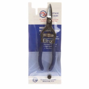 May include: A pair of high-quality shears with blue handles, packaged in a clear plastic sleeve. The shears have a silver blade and a spring mechanism. The packaging includes text that reads "Heritage Cutlery" and "High Scissors".