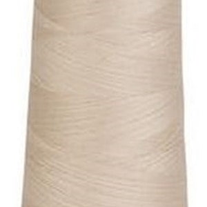 May include: A spool of beige thread with the word "Signature" printed on the label.