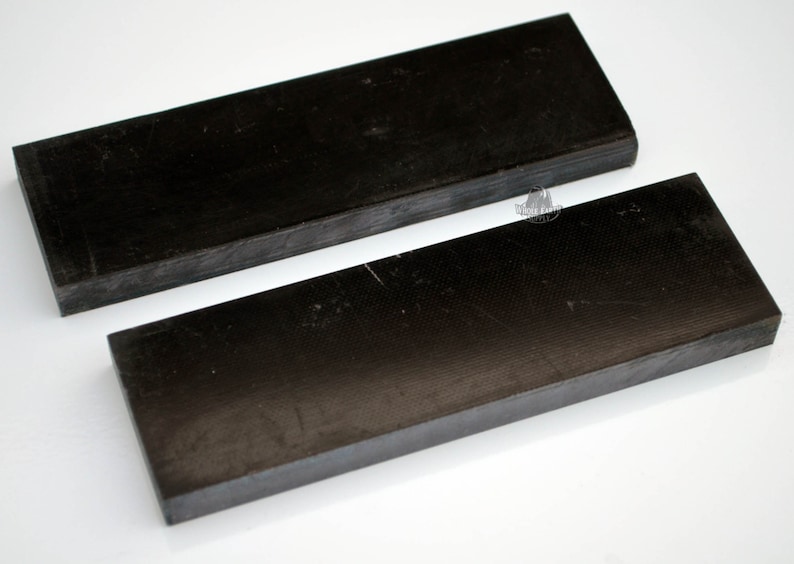 May include: Two black rectangular pieces of wood, possibly for crafting or woodworking projects.