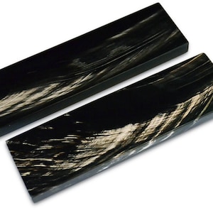 May include: Two black and white patterned knife scales, made from stabilized wood, for crafting custom knives.