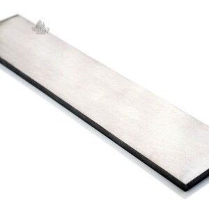 May include: A long, rectangular, silver-colored metal bar. The bar is smooth and has a slightly reflective surface.