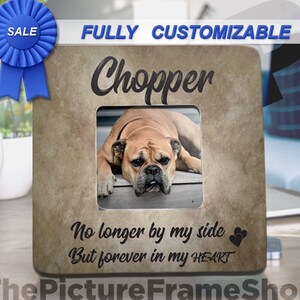 May include: A square, tan-colored picture frame with the name "Chopper" above a photo of a dog. The text "No longer by my side But forever in my HEART" is below the photo. A blue ribbon with "SALE" is in the upper left.