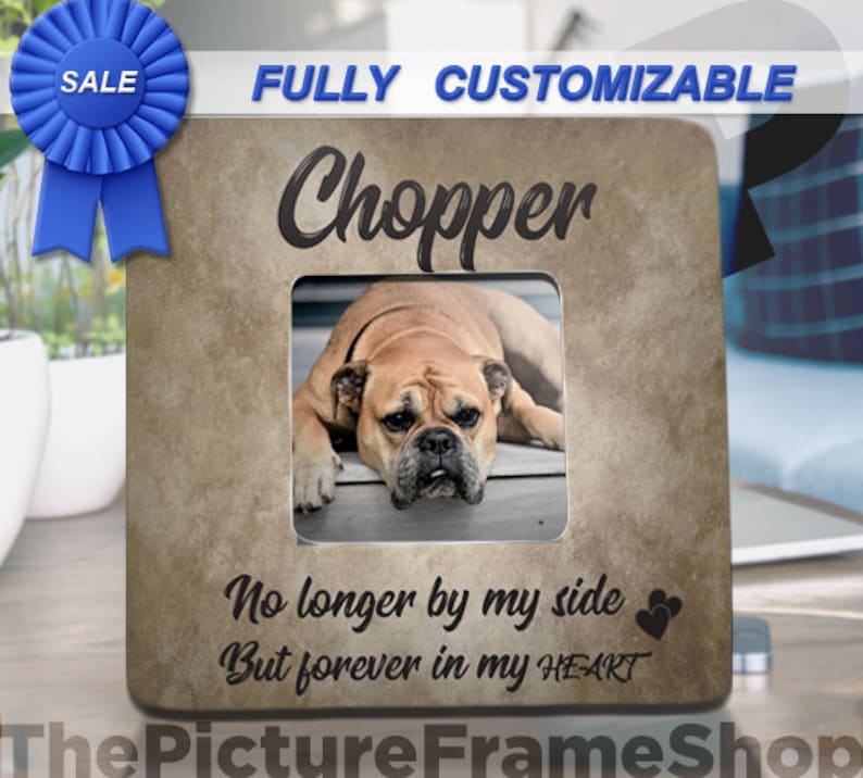 May include: A square, tan-colored picture frame with the name "Chopper" above a photo of a dog. The text "No longer by my side But forever in my HEART" is below the photo. A blue ribbon with "SALE" is in the upper left.