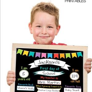 May include: A wooden framed chalkboard sign with the text "Jackson's First day of School". The sign includes the child's age, height (114 cm), favorite book, teacher's name, and favorite song. The sign is decorated with colorful bunting.