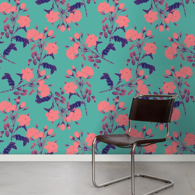 May include: A teal blue wallpaper with a pink floral pattern. A brown leather chair with a chrome frame sits in front of the wallpaper.