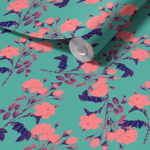 May include: Teal wallpaper with a pink floral pattern. The wallpaper features a repeating pattern of pink roses with dark blue leaves and stems. The wallpaper is rolled up and partially unrolled, showing the pattern.