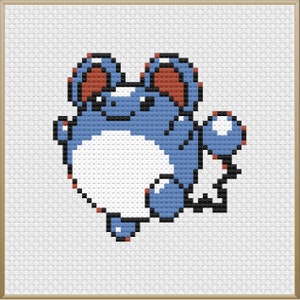 May include: Cross-stitch design of a blue creature with large ears, a white belly, and red accents. The pixelated artwork is framed in a light brown border, set against a white background.
