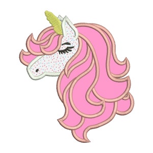 May include: A pink unicorn head with a yellow horn and closed eyes. The unicorn's mane is pink and curly.
