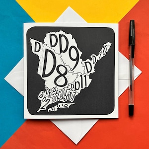 May include: Black and white greeting card featuring a map of a city with the numbers D8 and D9 in large font and other numbers in smaller font.