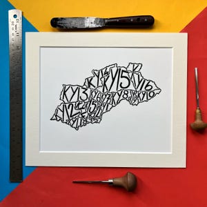 May include: A black and white print of a map of Kentucky, with the state's postal code "KY" repeated throughout the outline of the state.
