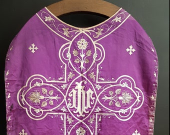 Antique priest chasuble. Purple liturgical vestment.