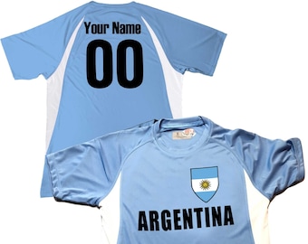 May include: Light blue soccer jersey with white accents and the Argentinian flag on the chest. The jersey has the text "ARGENTINA" and a number "00" on the back. The text "Your Name" is above the number.