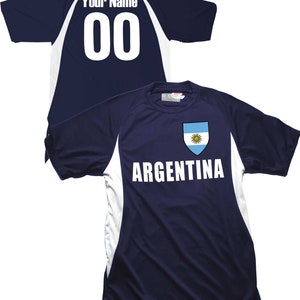 May include: A navy blue soccer jersey with white accents and the word "ARGENTINA" printed on the front. The jersey features the Argentine flag on the chest and a blank space on the back for a name and number.