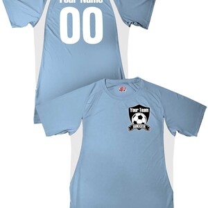 May include: A light blue soccer jersey with white accents. The back of the jersey has the text "Your Name" and the number "00". The front of the jersey has a black and white soccer ball logo with the text "Your Team Soccer".