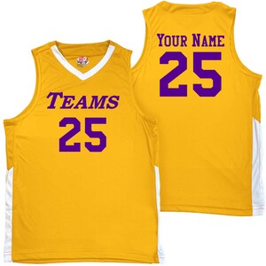 gold and white basketball jersey with purple heat applied vinyl lettering