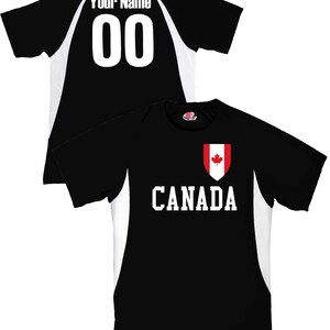 May include: Black and white Canada soccer jersey with the word "CANADA" in white block letters. The jersey features a Canadian flag crest and the text "Your Name" and the number "00" on the back.