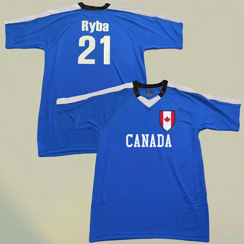 May include: Two blue athletic jerseys. One jersey has the name "Ryba" and the number "21" in white on the back. The other jersey has the word "CANADA" in white and a Canadian flag emblem on the front.