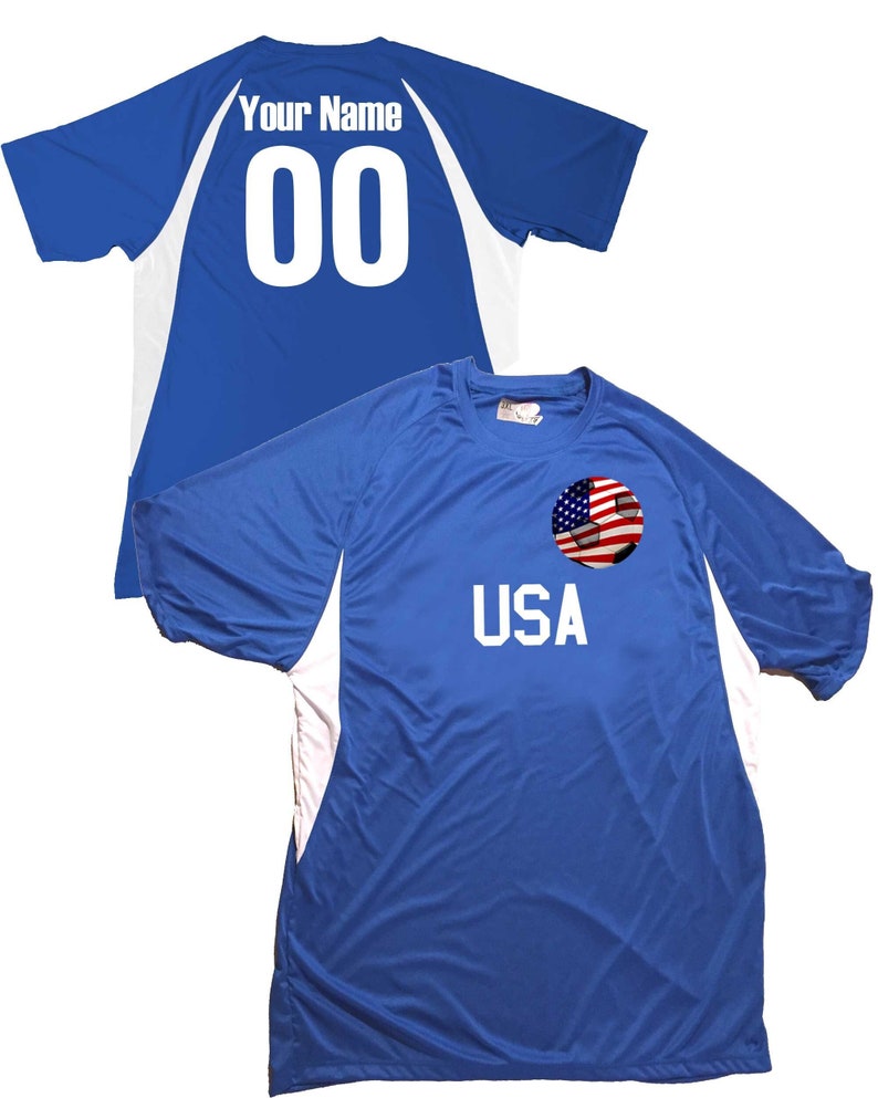 May include: Blue soccer jersey with white accents and a soccer ball with an American flag on the front. The back of the jersey has the text "Your Name" and the number "00" in white.