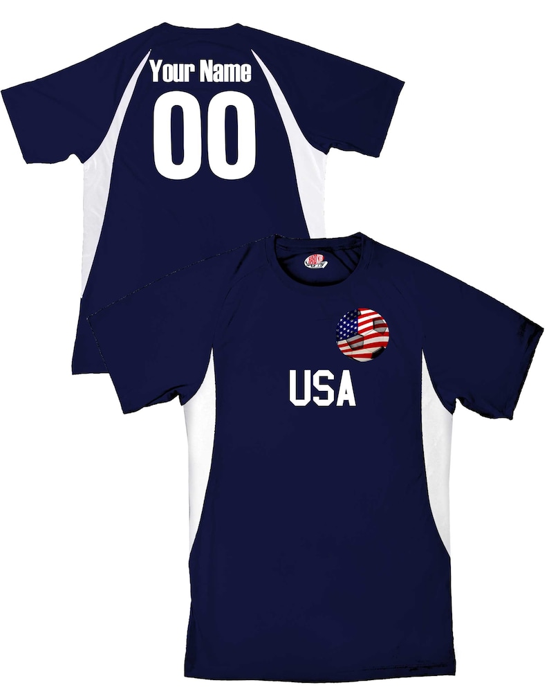 May include: A navy blue soccer jersey with white accents. The jersey has a soccer ball with an American flag on it and the word "USA" printed on the front. The back of the jersey has a white number "00" and the words "Your Name" printed on it.