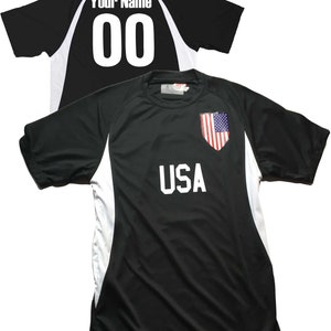 May include: Black soccer jersey with white accents and the word "USA" printed on the front. The back of the jersey has a white number "00" and the text "Your Name".