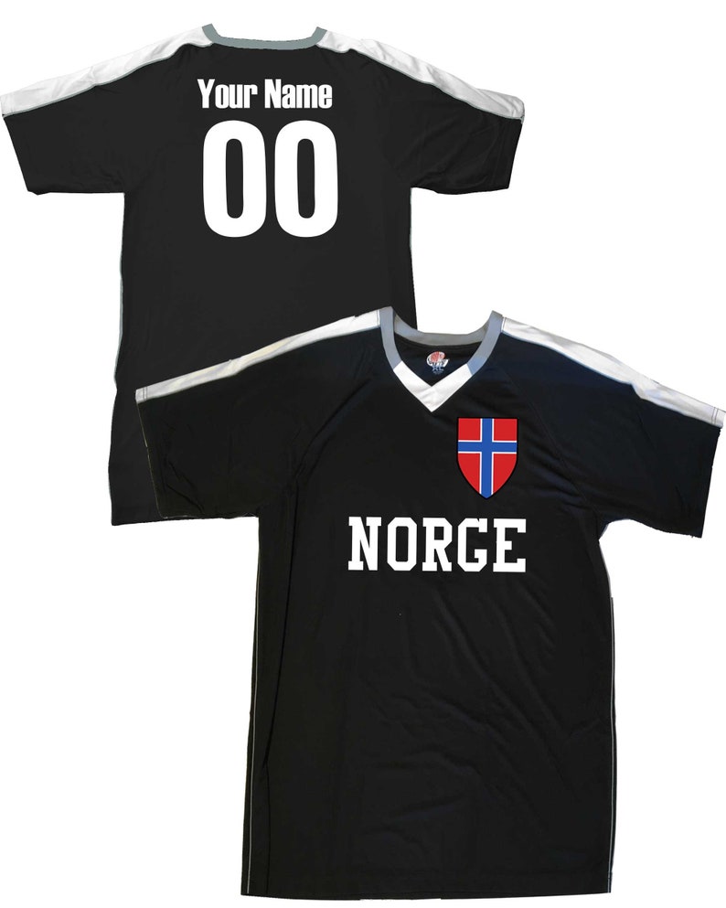 May include: Black soccer jersey with white accents and the word "NORGE" printed on the front. The jersey also features the Norwegian flag on the chest. The back of the jersey has a white number "00" and the text "Your Name" printed on it.