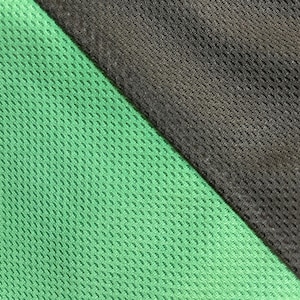 May include: Close-up of a green and black mesh fabric. The green fabric is on the left, and the black fabric is on the right, separated by a diagonal seam. The mesh has a small, evenly spaced pattern.