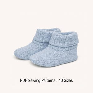 May include: A pair of light blue knit booties with a folded cuff design. The text below the booties reads PDF Sewing Patterns . 10 Sizes. The booties feature a textured, soft-looking knit construction with a rounded toe and a simple ankle height.