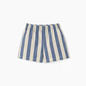 May include: A pair of shorts featuring a vertical striped pattern in blue and off-white. The garment has an elasticized waistband with gathered fabric detail and a straight-cut hemline, constructed from a woven textile material.