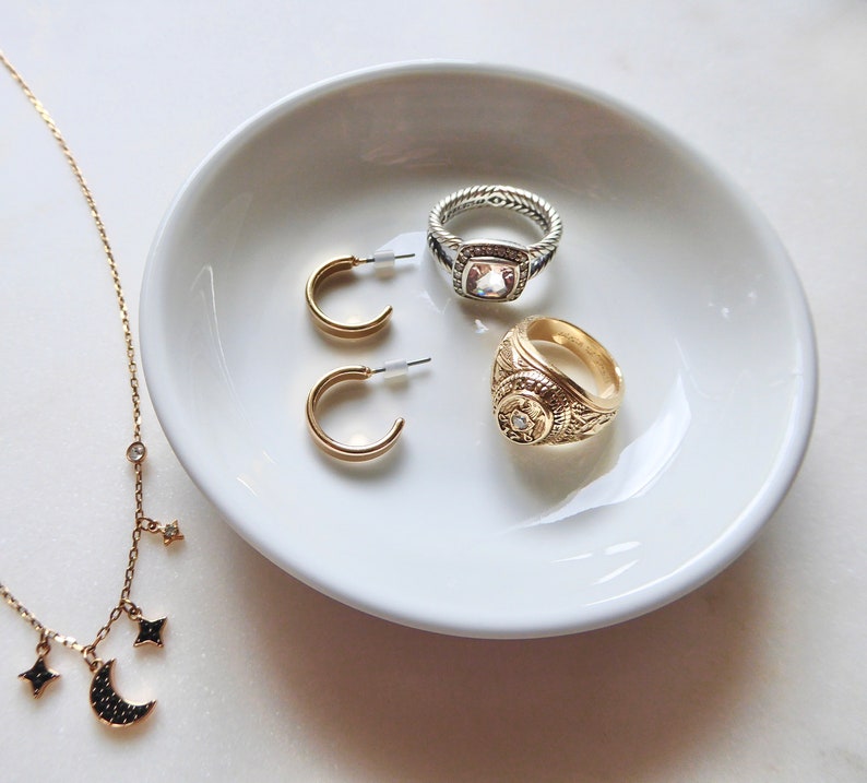 Blank dish with jewelry inside to show size. 4 inches in diameter.